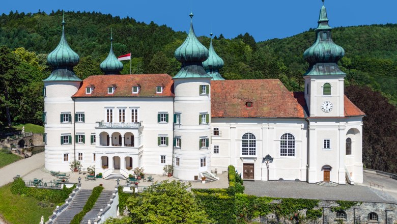 Artstetten Castle, © M. Haslinger Artstetten Castle with towers and gardens against a wooded background.