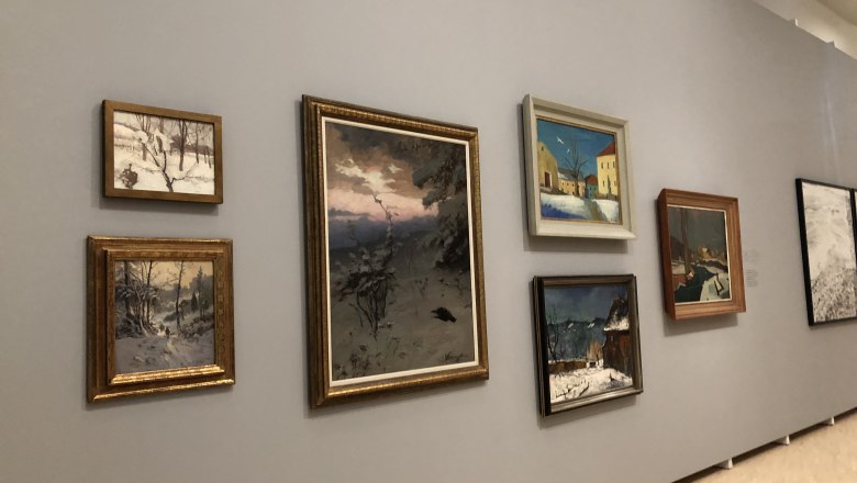 Exhibition in the Landesgalerie, © Donau NÖ Tourismus/JS A wall in a gallery with several paintings showing winter landscapes.
