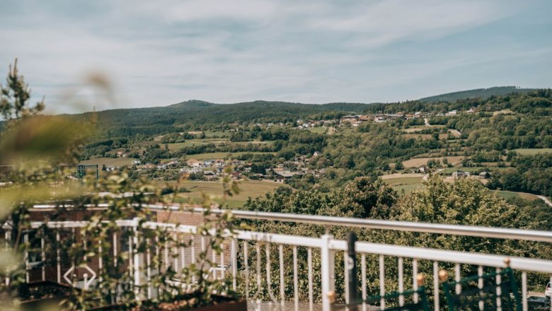 Zum Goldenen Löwen, © Zum Goldenen Löwen Blick von einer Terrasse auf eine hügelige Landschaft mit Dörfern und Wäldern im Hintergrund.
