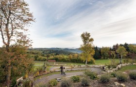 Bad Traunstein, Lebensweg, Wohnzimmer im Freien, © C) Lebensweg, Studio Kerschbaum.jpg In der sanften Hügellandschaft entfaltet sich ein malerisches Panorama, das die Seele berührt. Die bunten Blätter der Bäume kündigen den Herbst an und laden zu einem entspannenden Spaziergang ein. Hier, wo die Natur in voller Pracht erstrahlt, findet man den perfekten Ort, um die Ruhe und Schönheit der Umgebung zu genießen.