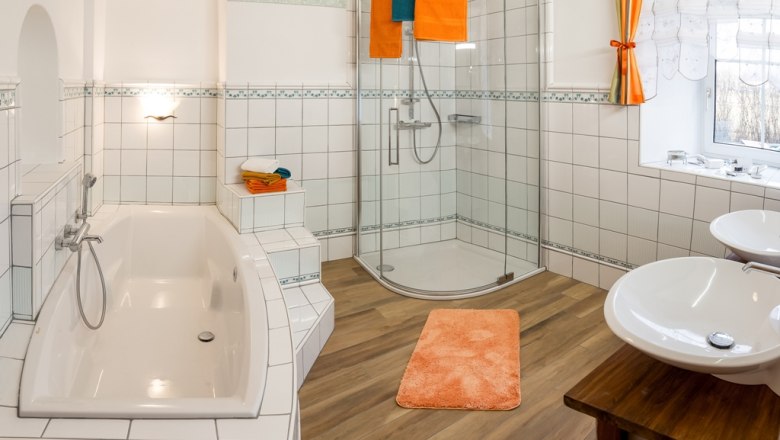 Bad, © Landhaus Lunkowitz Modernes Badezimmer mit Badewanne, Dusche und Doppelwaschbecken.