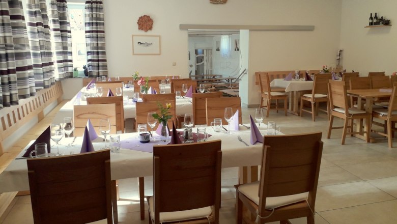 Wine tavern, © Familie Piller Interior view of a cozy wine tavern with laid tables and wooden furniture.