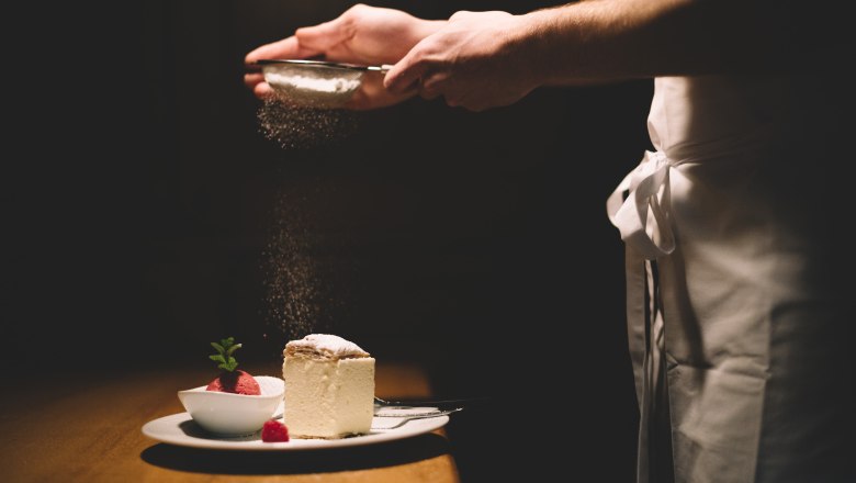 A plate with cream slice and raspberry sorbet, sprinkled with powdered sugar.
