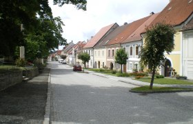 Straße in Drosendorf Stadt mit historischen Häusern und Bäumen.