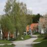 A village with red roofs and blossoming trees in spring.