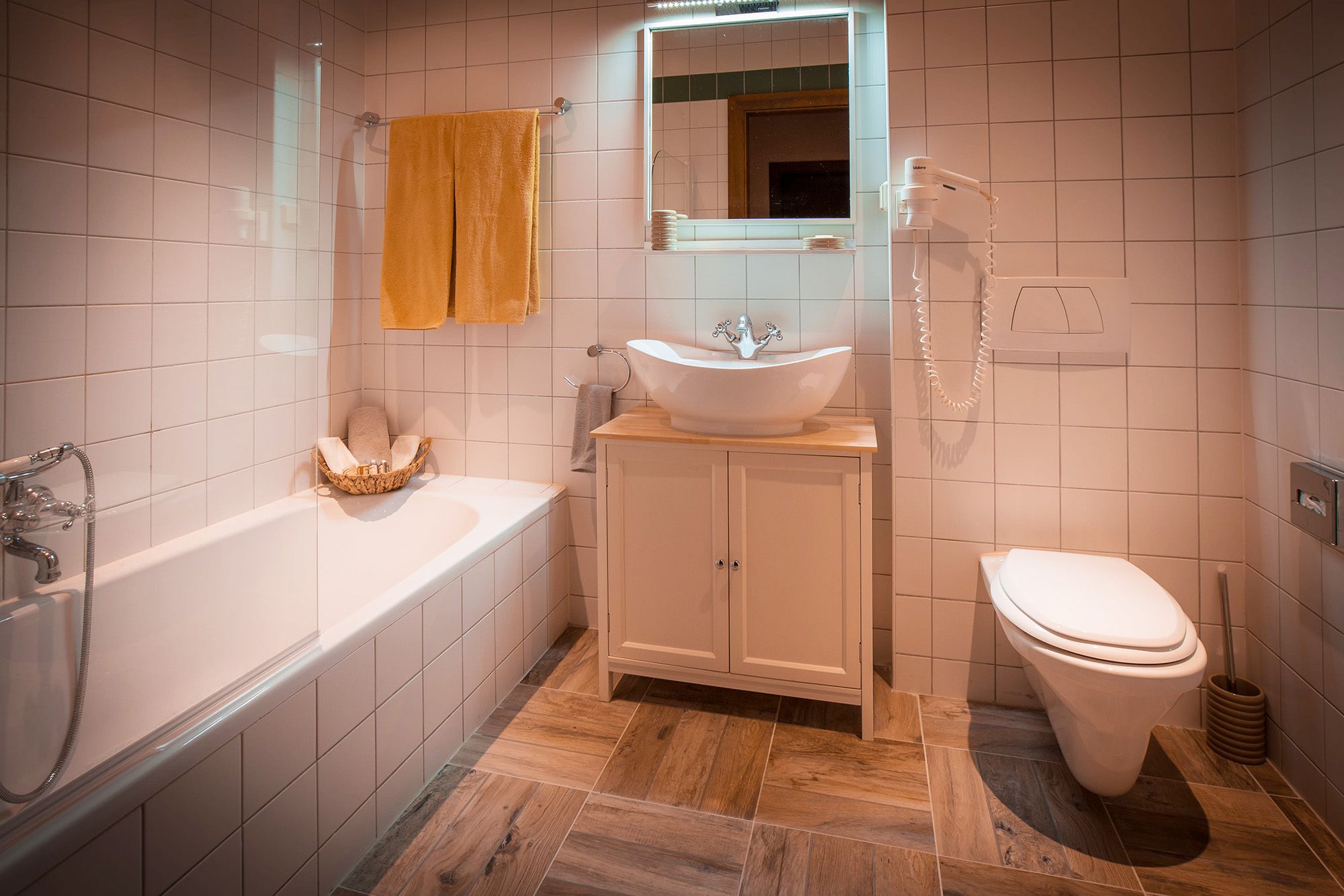 Modernes Badezimmer mit Badewanne, Waschbecken und Toilette.
