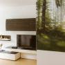 Modern living area with TV, shelves and large forest picture on the wall.
