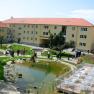 Inner courtyard with pond, seating area and people.