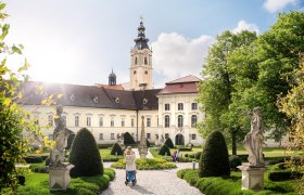 Altenburg Abbey with garden and statues in the foreground.