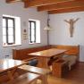 Rustic room with wooden furniture, wooden beamed ceiling and wall decoration.