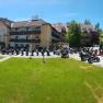 Hotel Waldviertler-Hof with many motorcycles parked in front of it.